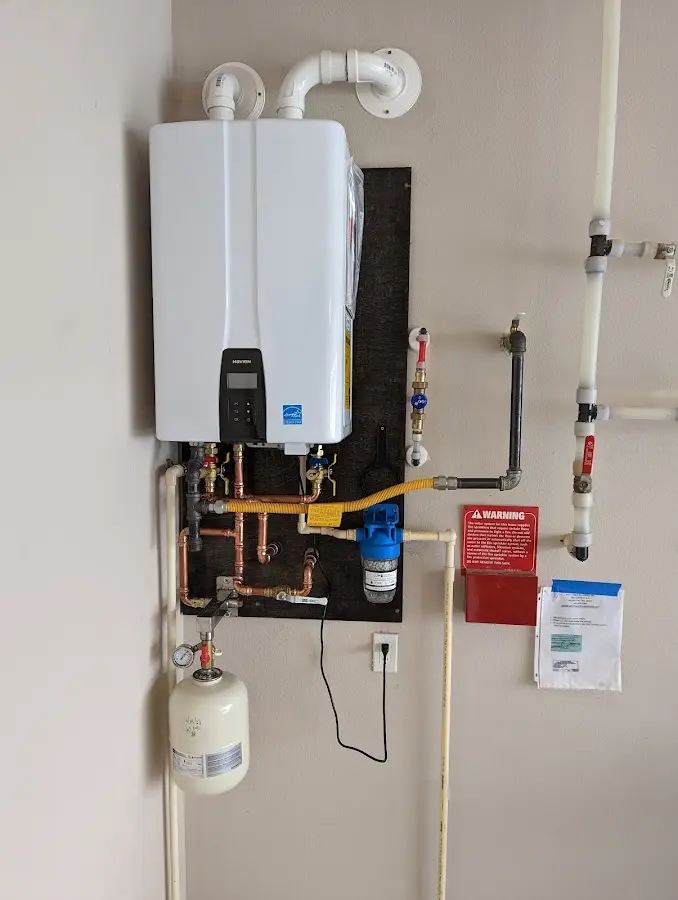 Professional plumber installing copper piping in a King City home